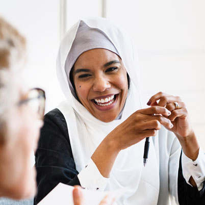 A person laughs in a social setting.